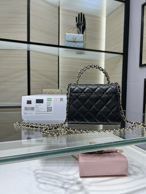 Black quilted Chanel shoulder bag with long chain strap and flap front, gold clasp