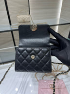 Black Chanel quilted mini bag with chain strap and round turn-lock closure