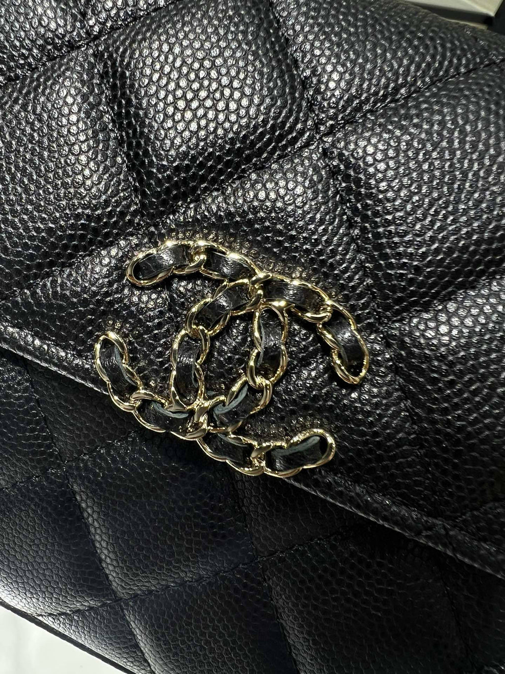 Black textured leather Chanel bag with gold chain-link hardware on the front