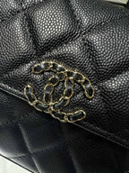 Black textured leather Chanel bag with gold chain-link hardware on the front