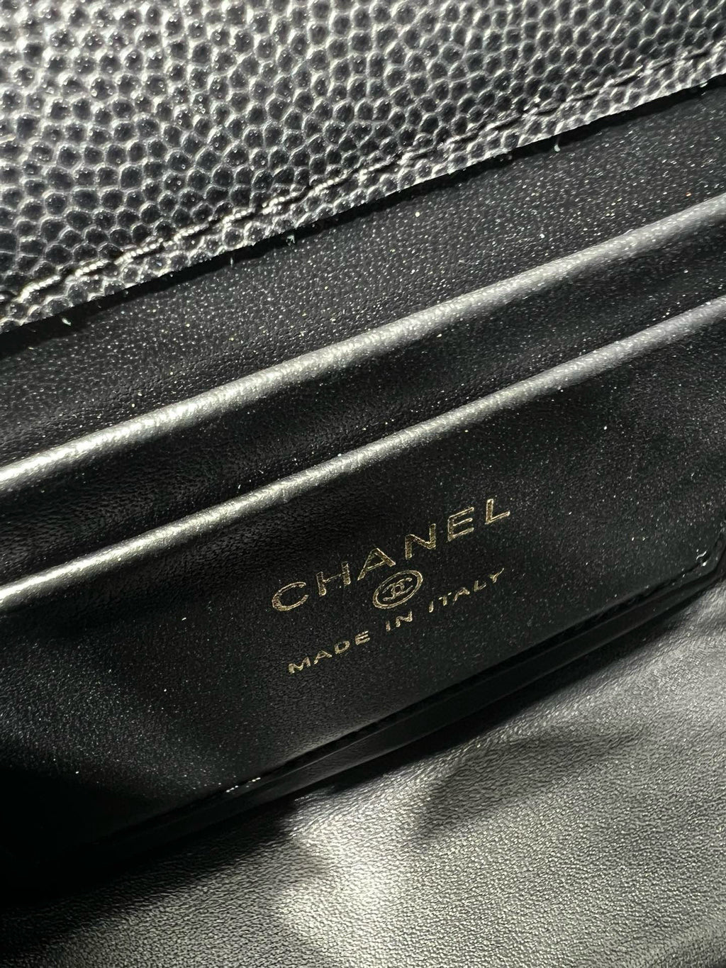 Black Chanel bag base with embossed CHANEL and MADE IN ITALY text