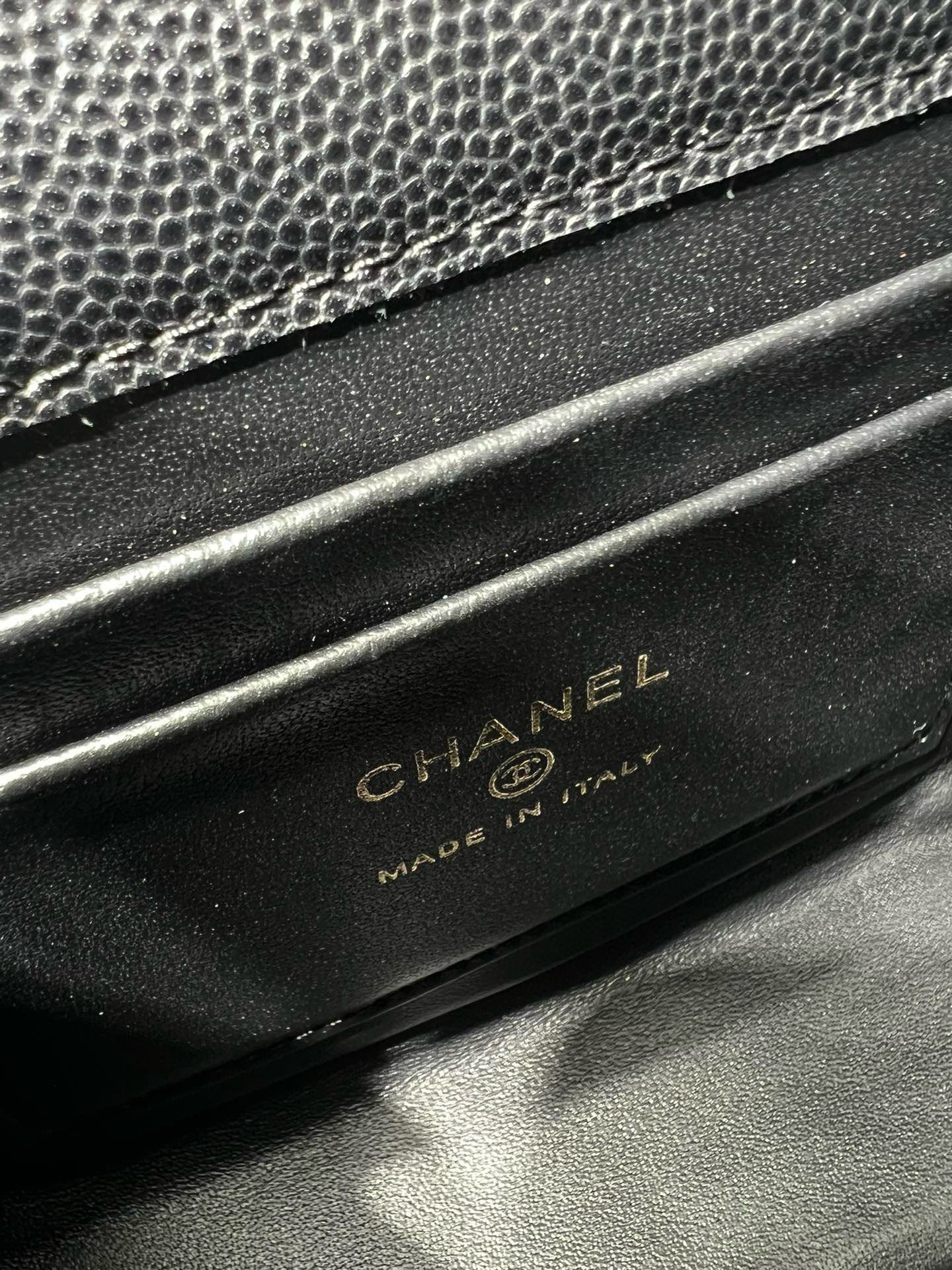 Black Chanel bag base with embossed CHANEL and MADE IN ITALY text
