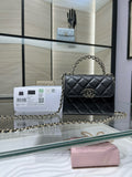 Black quilted Chanel shoulder bag with chain strap and flap closure, gold hardware