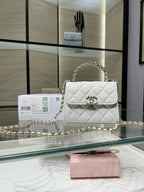 Chanel quilted white leather flap bag with gold chain strap and turn-lock clasp