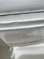 Chanel interior label reading CHANEL and MADE IN ITALY on white leather bag