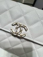 Chanel white quilted leather bag detail with gold chain and turn-lock clasp