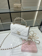 Chanel quilted white leather mini flap bag with gold chain strap and turn-lock clasp