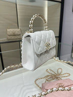 Chanel quilted white leather mini flap bag with top handle and gold chain strap