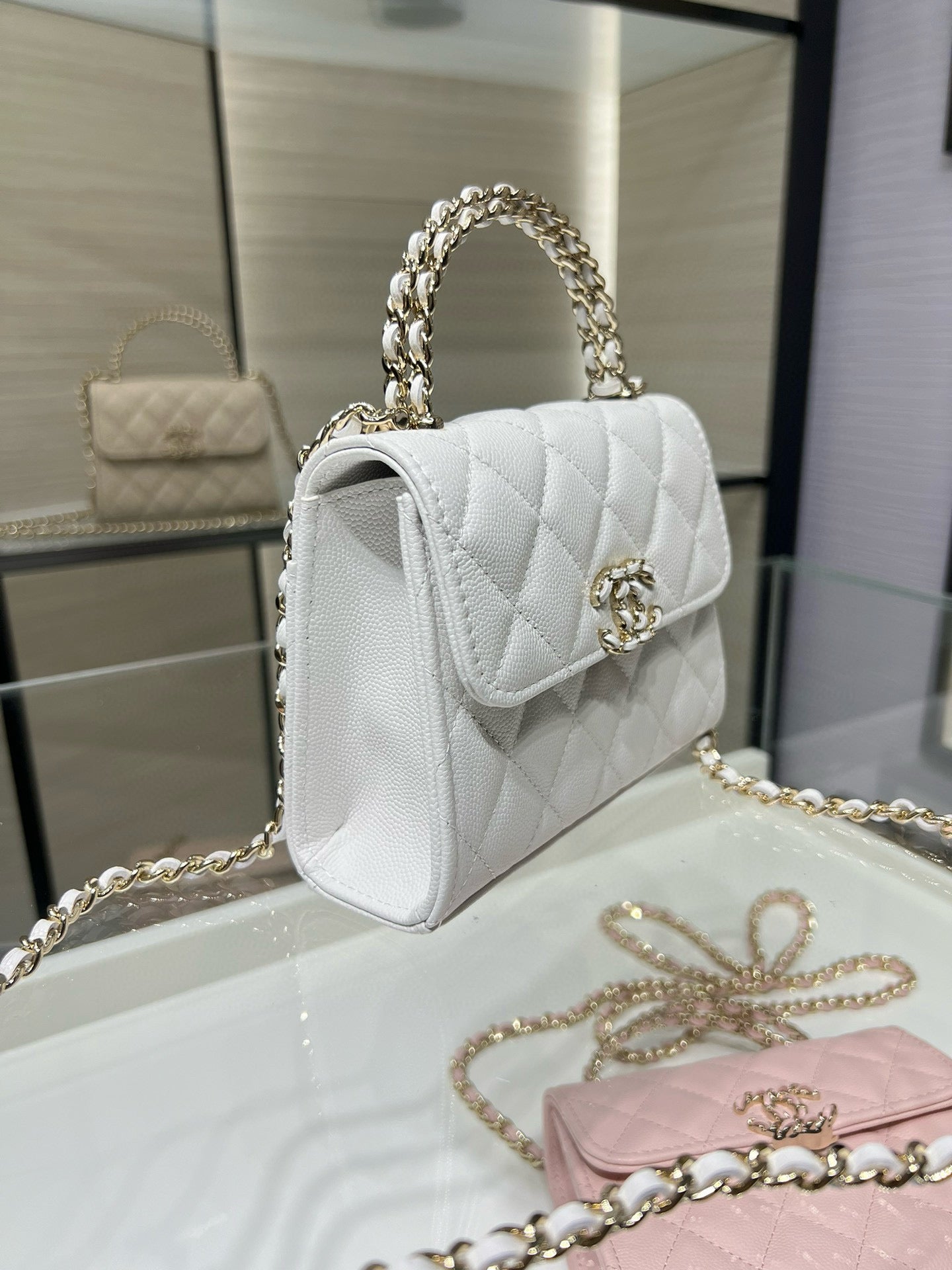 Chanel quilted white leather mini flap bag with top handle and gold chain strap
