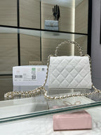 Chanel quilted white leather mini flap bag with gold chain strap and turn-lock clasp