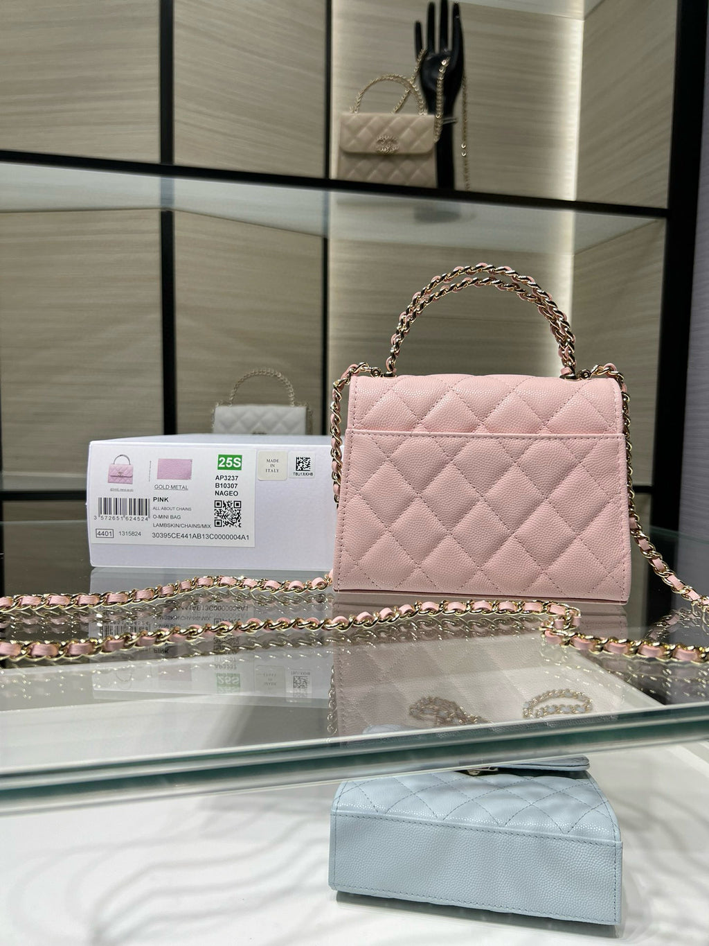 Pink quilted mini handbag with gold-tone chain strap and front flap clasp