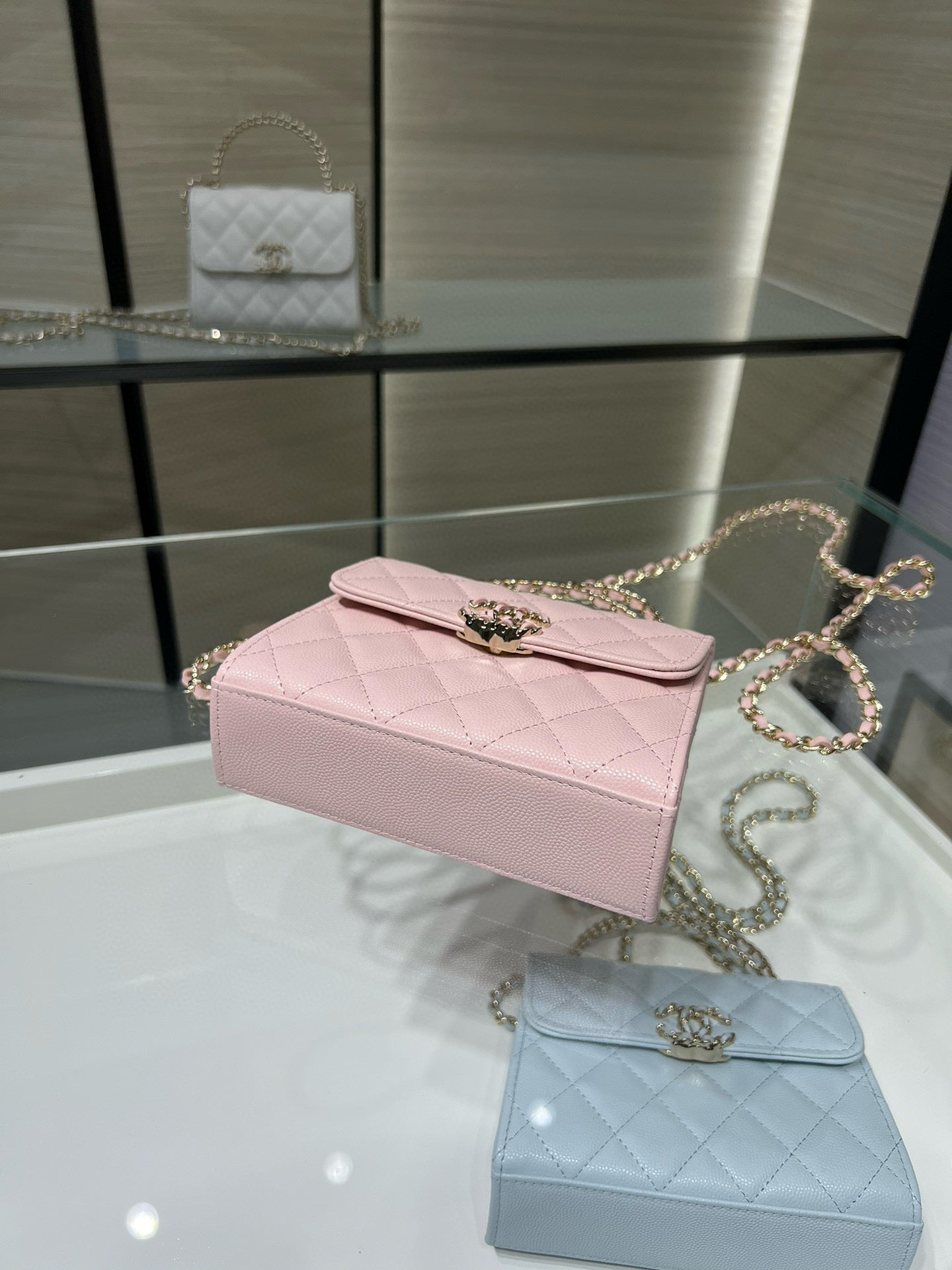 Pink quilted top-handle bag with gold-tone clasp and chain strap
