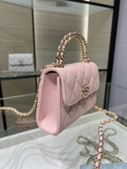 Pink quilted shoulder handbag with gold chain strap and front flap