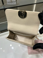 Chanel small cream shoulder bag with gold-tone logo turn-lock clasp