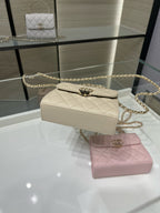 Chanel cream quilted flap shoulder bag with gold chain strap, side angle