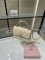 Chanel cream quilted small flap shoulder bag with gold chain strap, angled