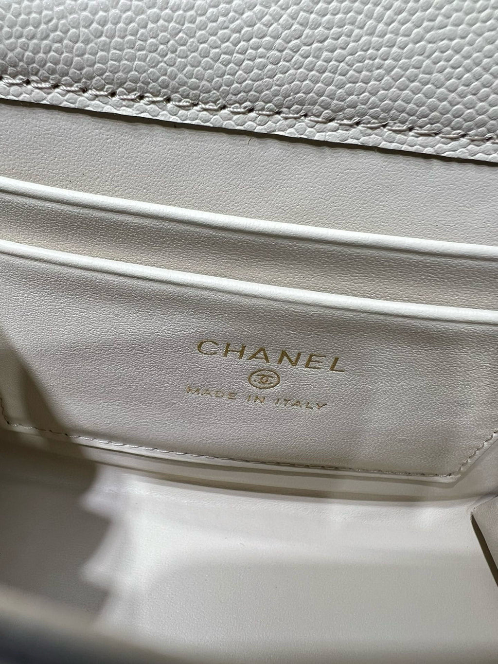 Chanel logo label on cream quilted interior flap, made in Italy text