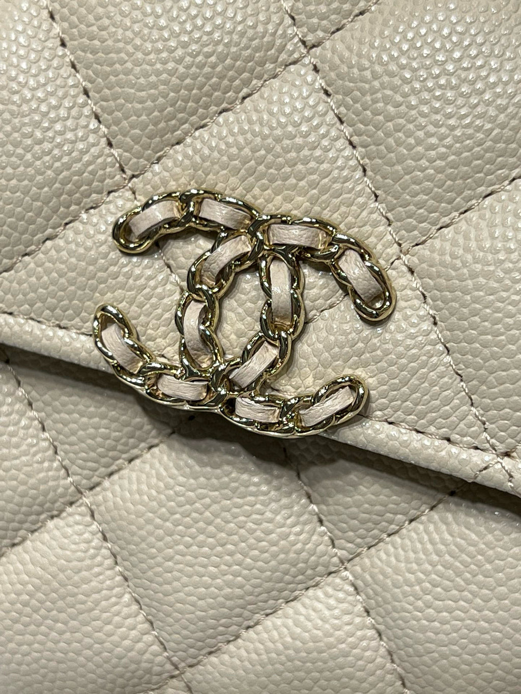 Chanel cream quilted bag with gold-tone chain detail on flap
