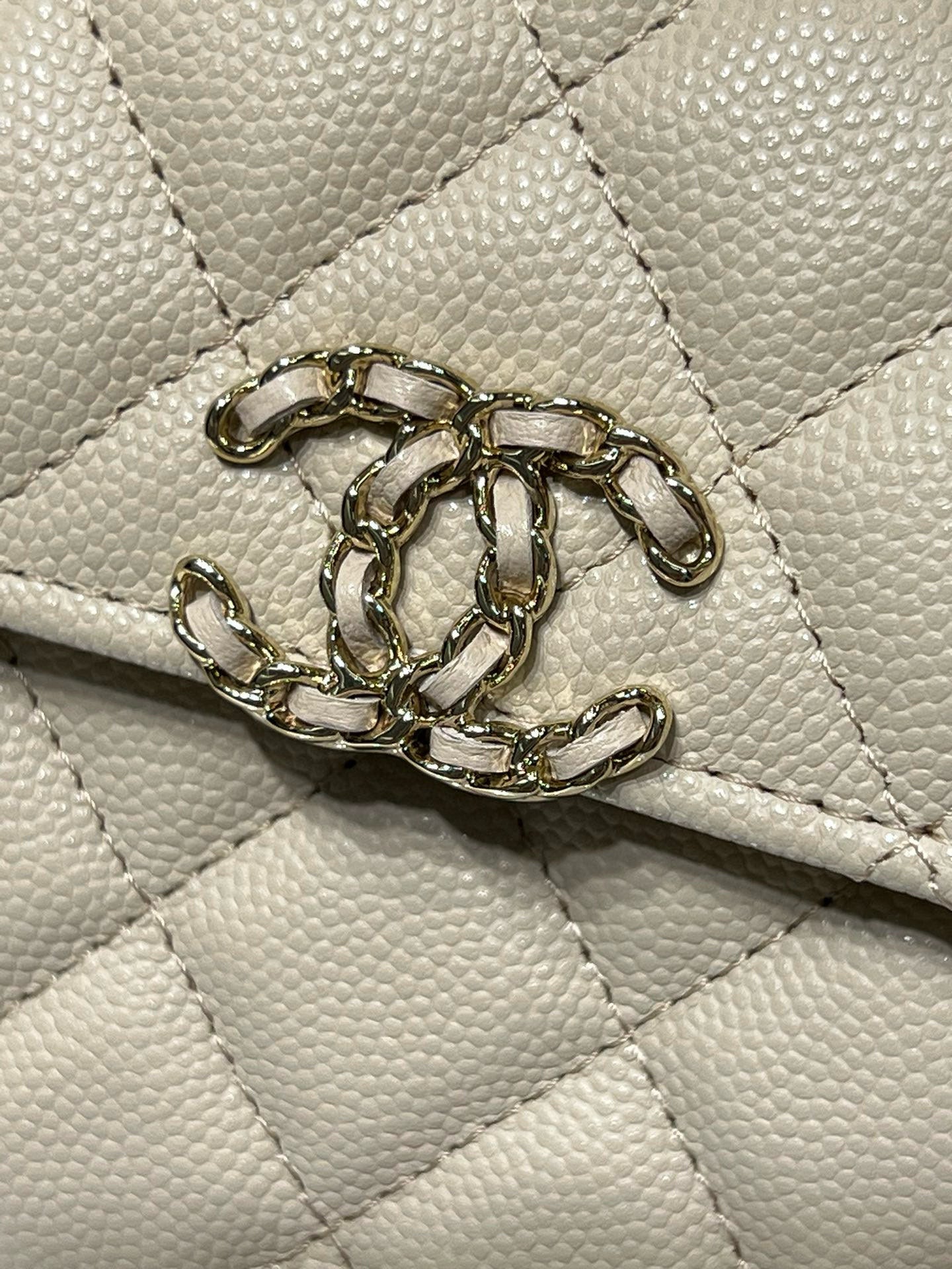 Chanel cream quilted bag with gold-tone chain detail on flap