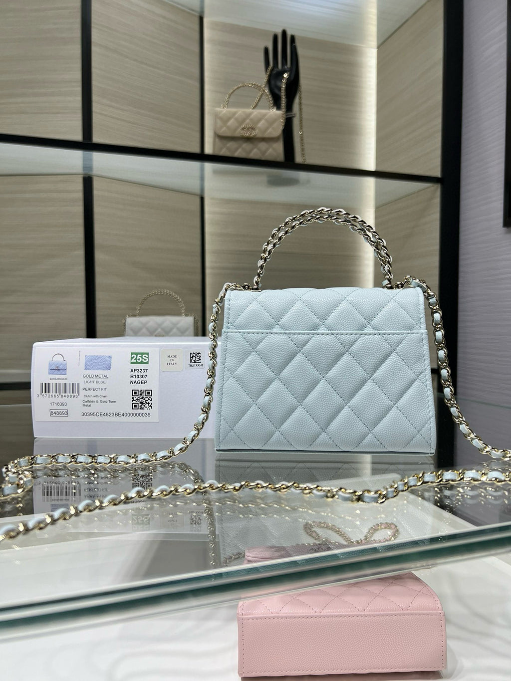 Light blue quilted handbag with flap closure and gold-tone chain shoulder strap