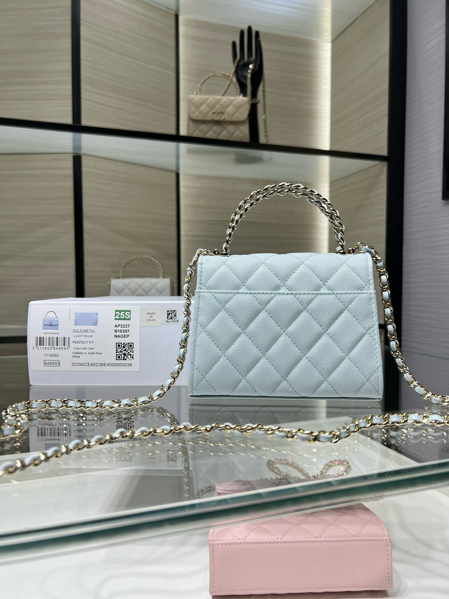 Light blue quilted handbag with flap closure and gold-tone chain shoulder strap