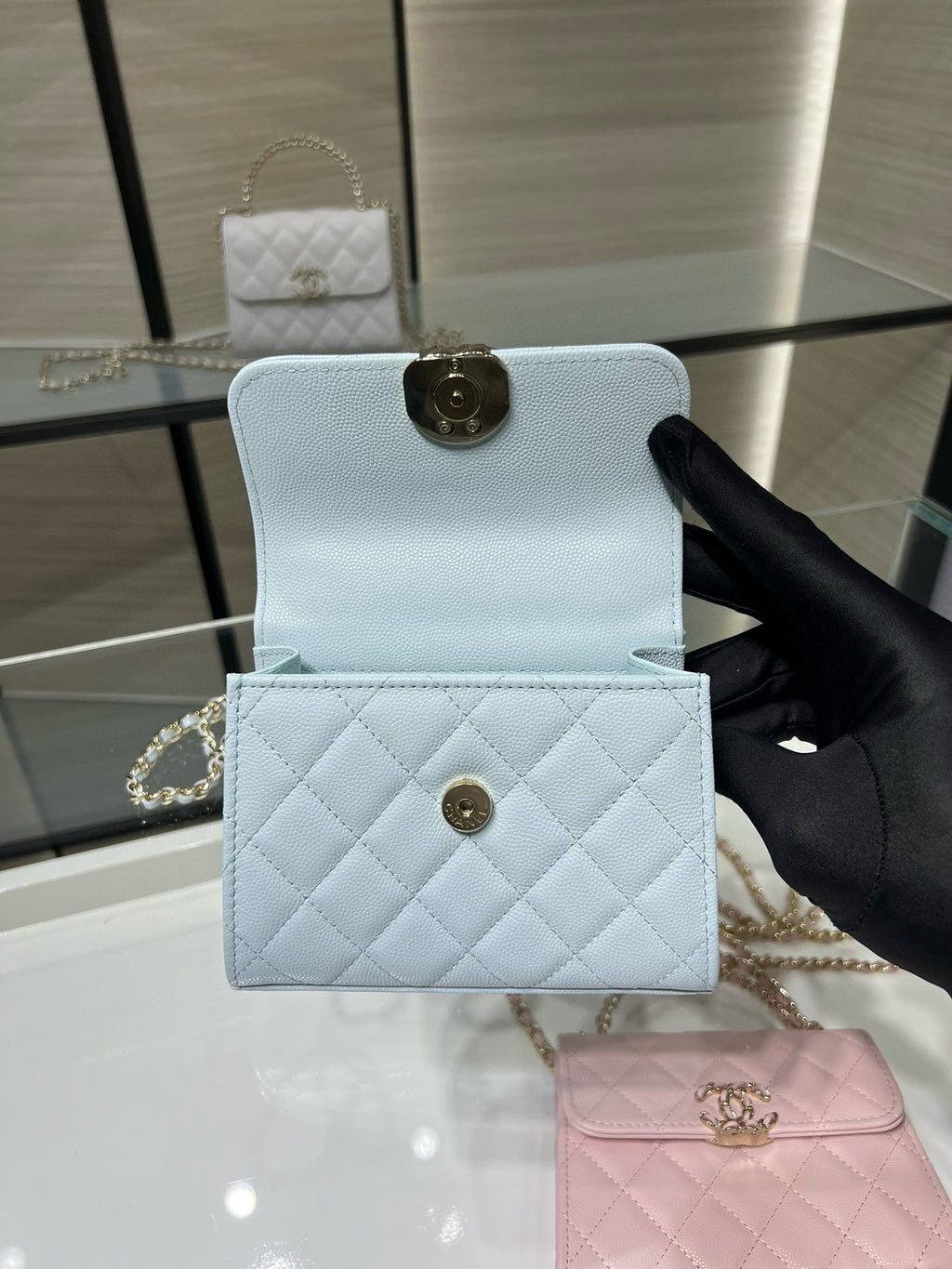 Light blue quilted cardholder with flap and gold-tone snap clasp