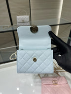 Light blue quilted cardholder with flap and gold-tone snap clasp