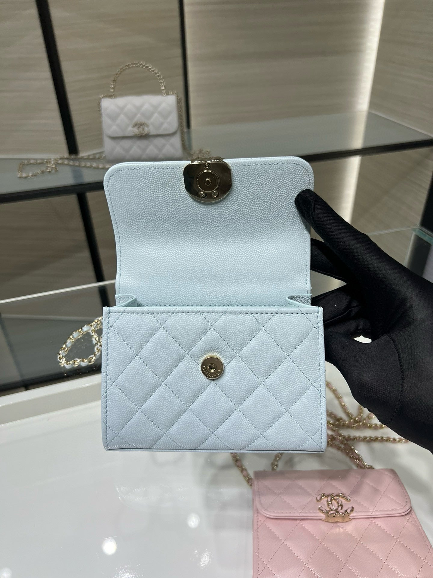 Light blue quilted cardholder with flap and gold-tone snap clasp
