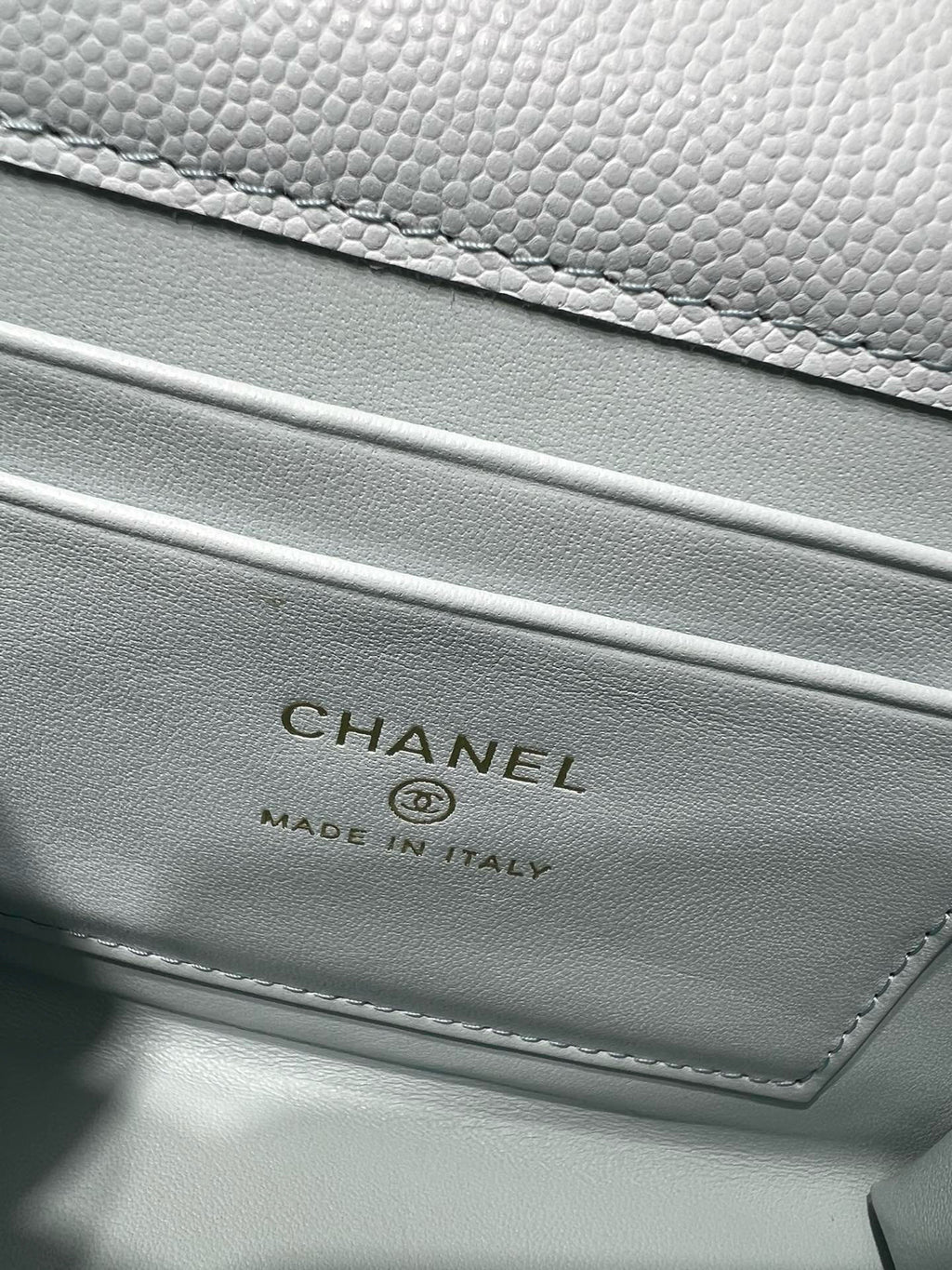 Light blue leather bag with CHANEL logo and Made in Italy text