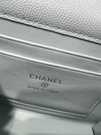 Light blue leather bag with CHANEL logo and Made in Italy text