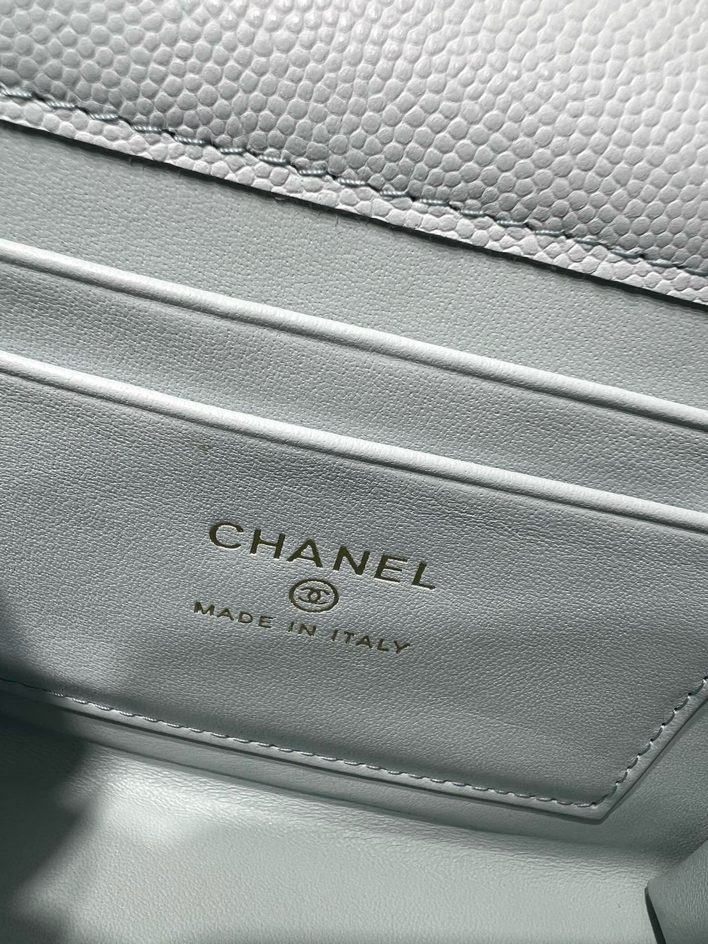 Light blue leather bag with CHANEL logo and Made in Italy text