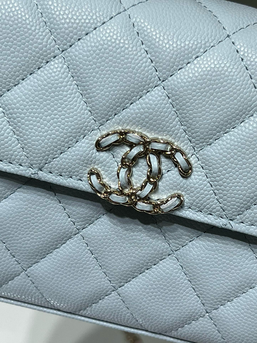 Light blue quilted leather flap detail with gold-tone chain link closure