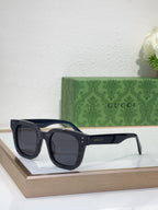 Gucci navy acetate sunglasses with dark lenses and thick square frames, front view