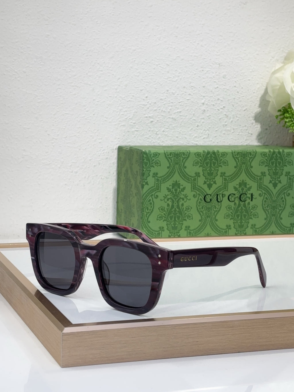 Gucci burgundy-accent sunglasses with dark lenses and oversized square frames