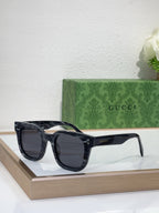 Gucci dark sunglasses with oversized square frames and dark lenses, front view