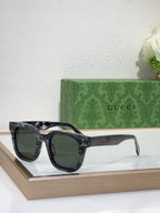 Gucci translucent dark sunglasses with black frames and dark tinted lenses, side angle