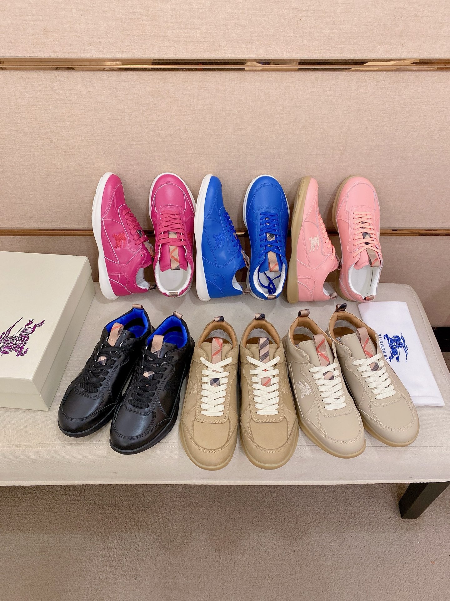 Assorted sneakers display: pink, blue, black, beige, and off-white pairs