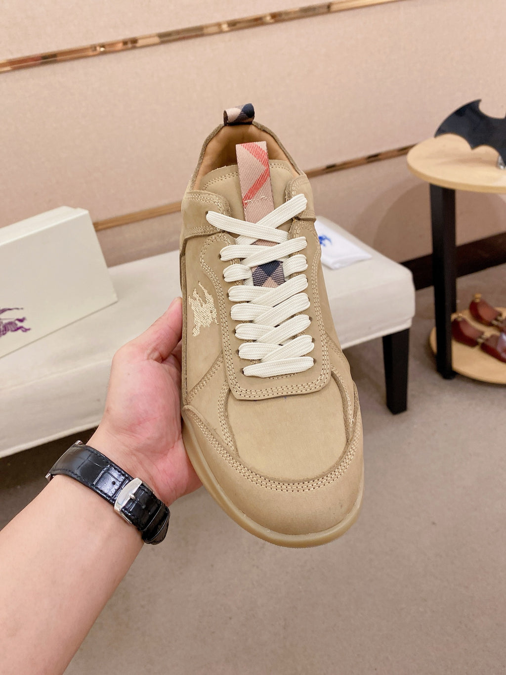 Beige lace-up sneaker with white laces, side panel detail, and patterned tongue lining