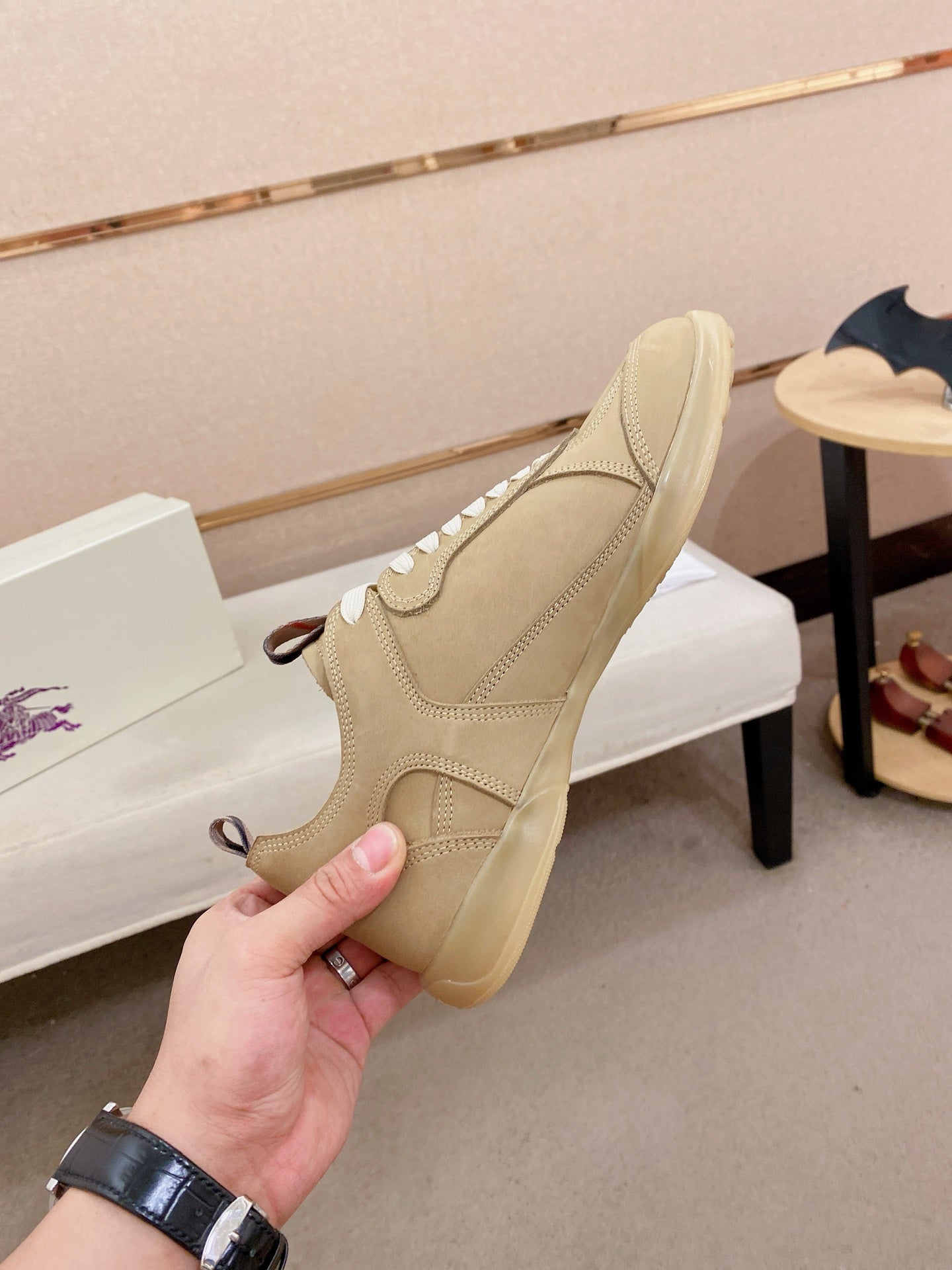 Beige lace-up sneaker with white laces and rear view of the cushioned collar
