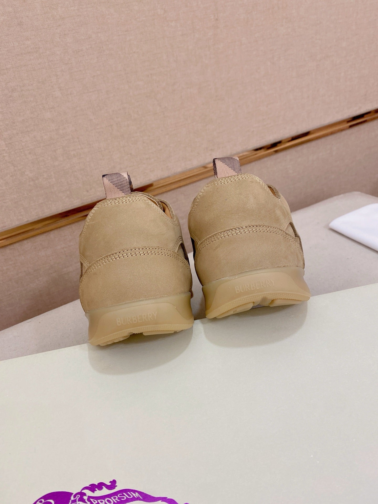 Beige lace-up sneaker pair showing backs with low-profile soles
