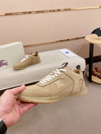 Beige lace-up sneaker with white laces and small logo detail on the side