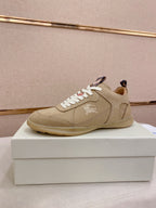 Beige lace-up sneaker with white laces, stitched upper, and low-profile rubber sole