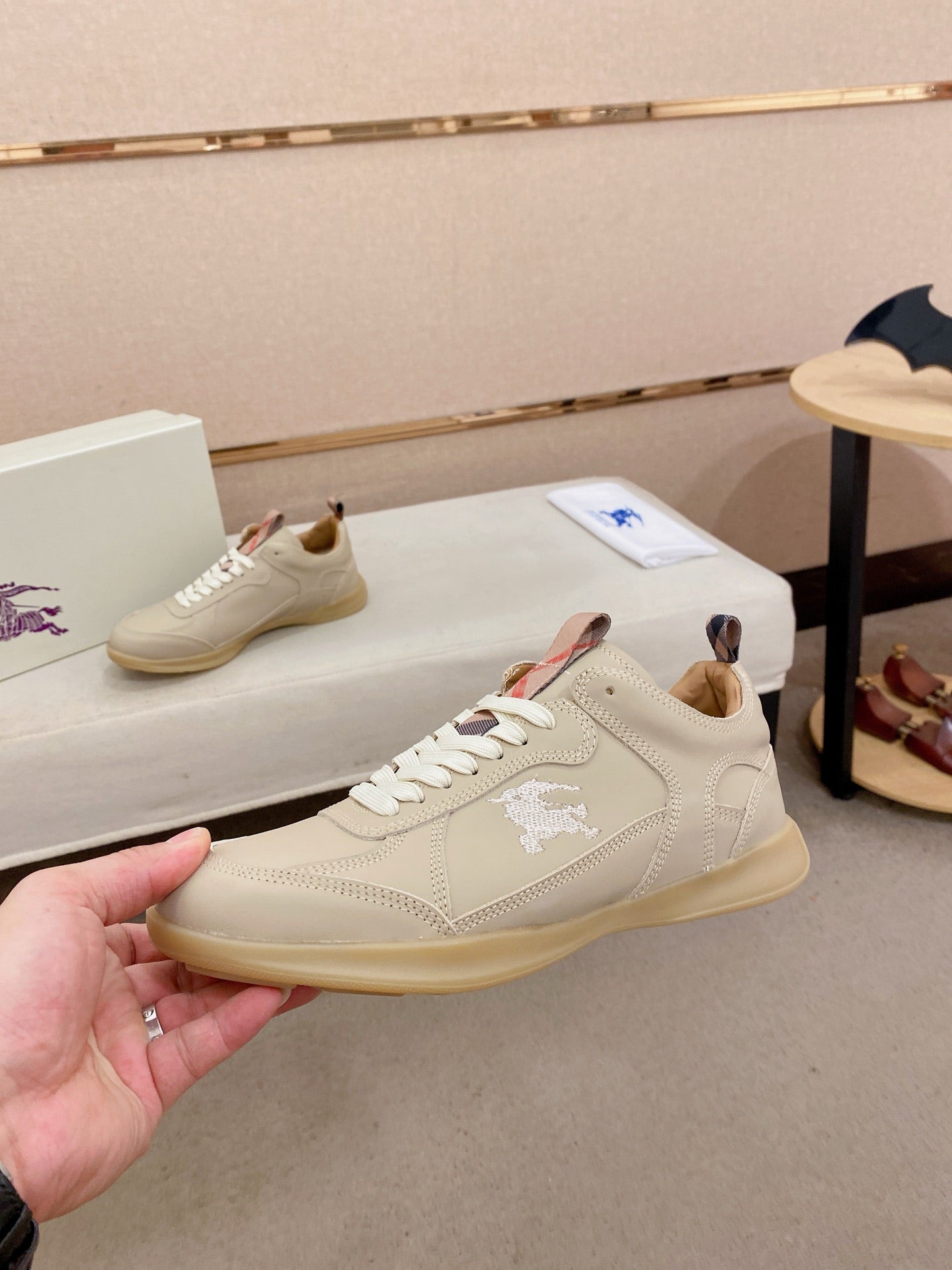 Cream leather sneakers with lace-up closure and embroidered horse logo on side