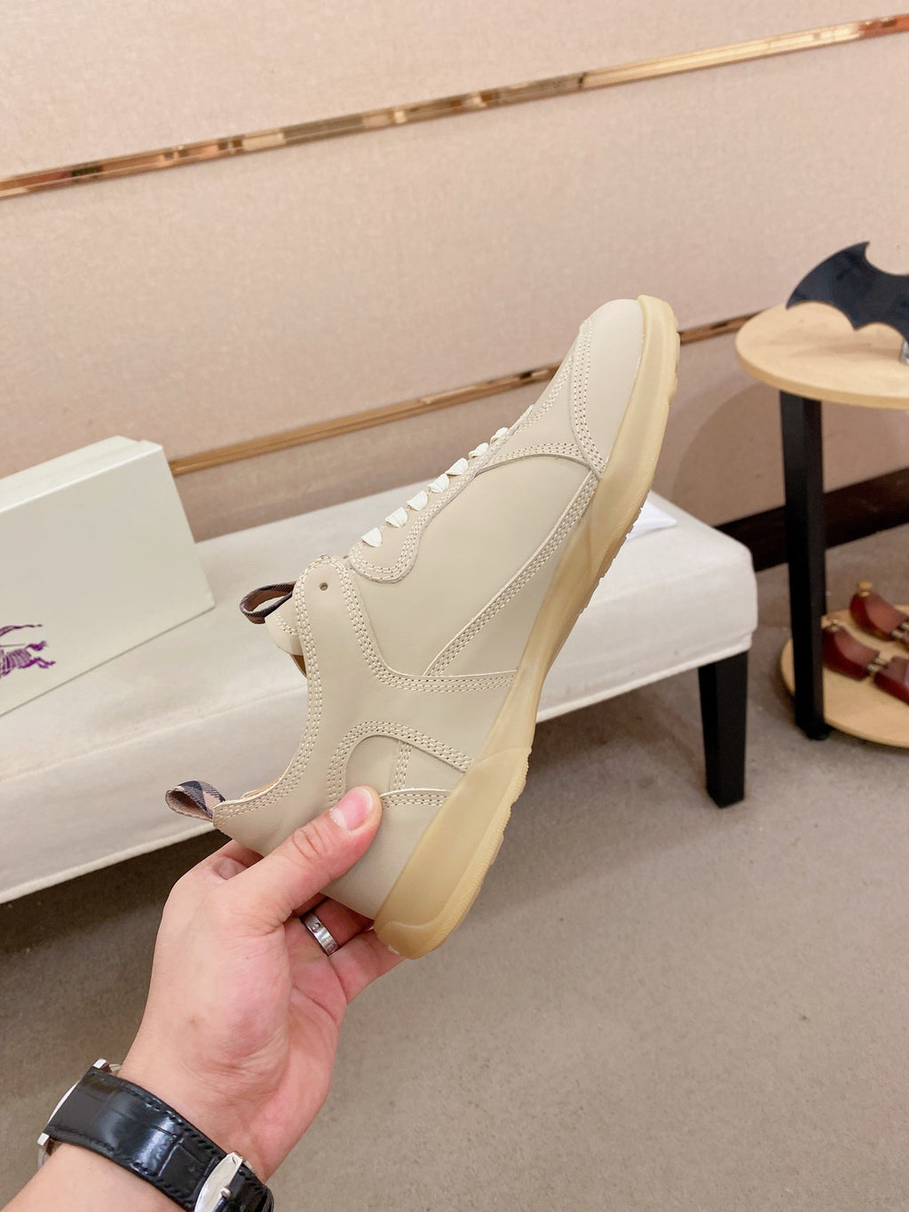 Cream sneaker with lace-up front, gum sole edge, and side profile detail