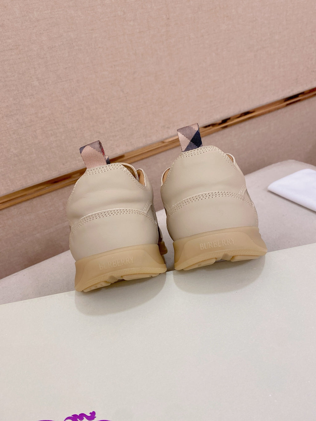 Back view of cream sneakers showing heel shape and tan rubber sole