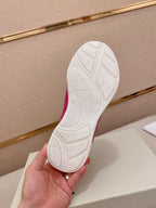 Burberry pink sneakers, rubber outsole tread view held in hand