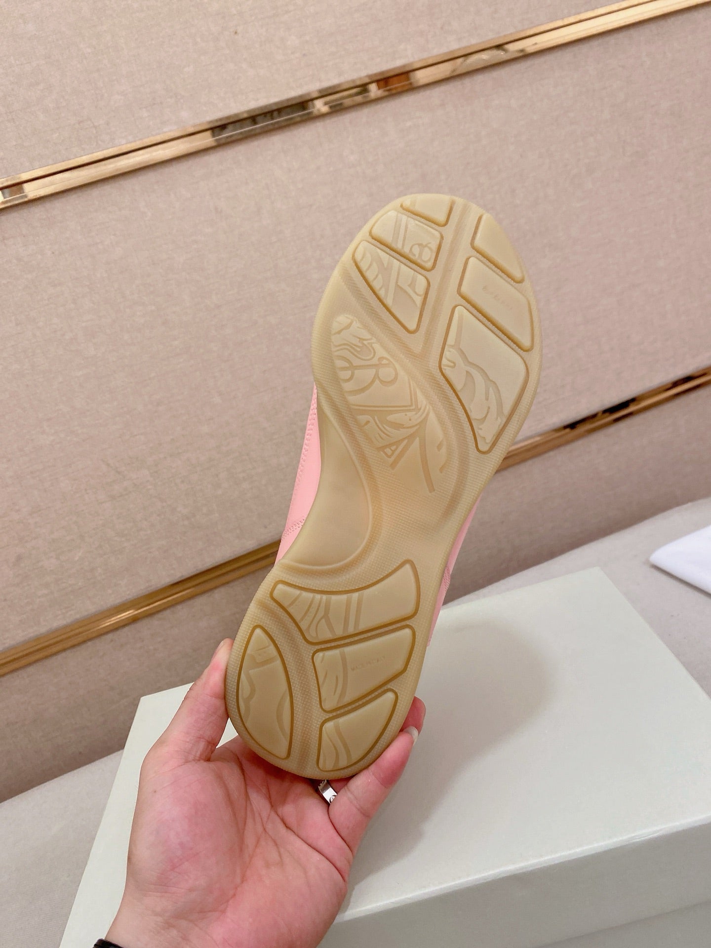 Sneaker outsole view with tread pattern and light gum rubber base