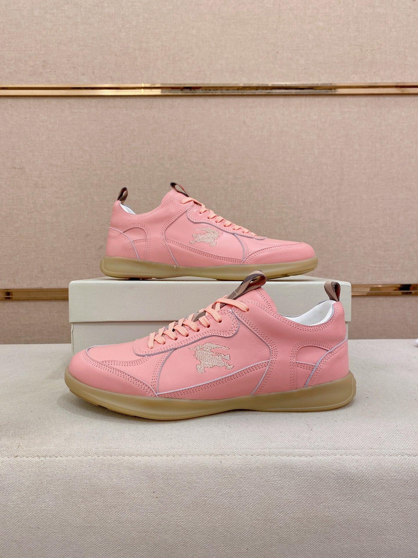 Burberry pink low-top sneakers on box, side crest logo and gum sole