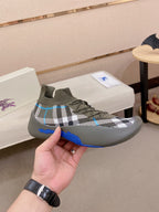 Gray knit sneakers with plaid knit upper and blue rubber sole detail