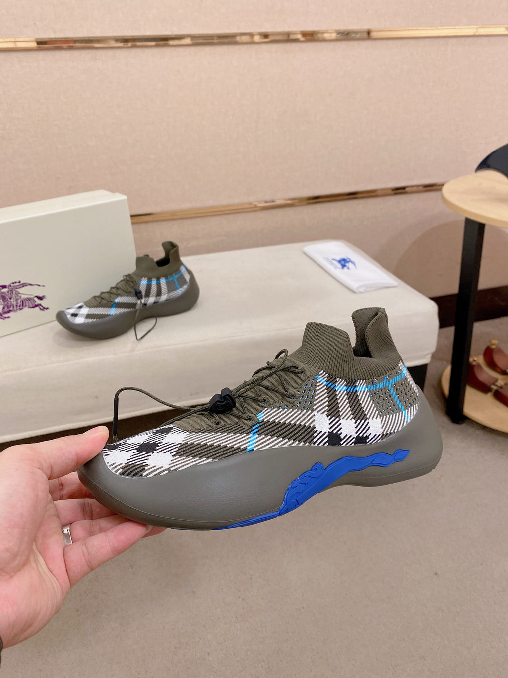 Gray knit lace-up sneakers with black-and-white plaid pattern and blue sole